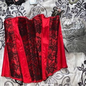 Red satin and black lace lace up corset with stockings.